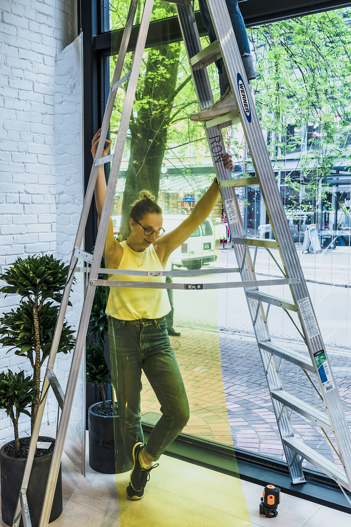 Cutler team member setting up the interior display for Inform's Window Display in Vancouver BC