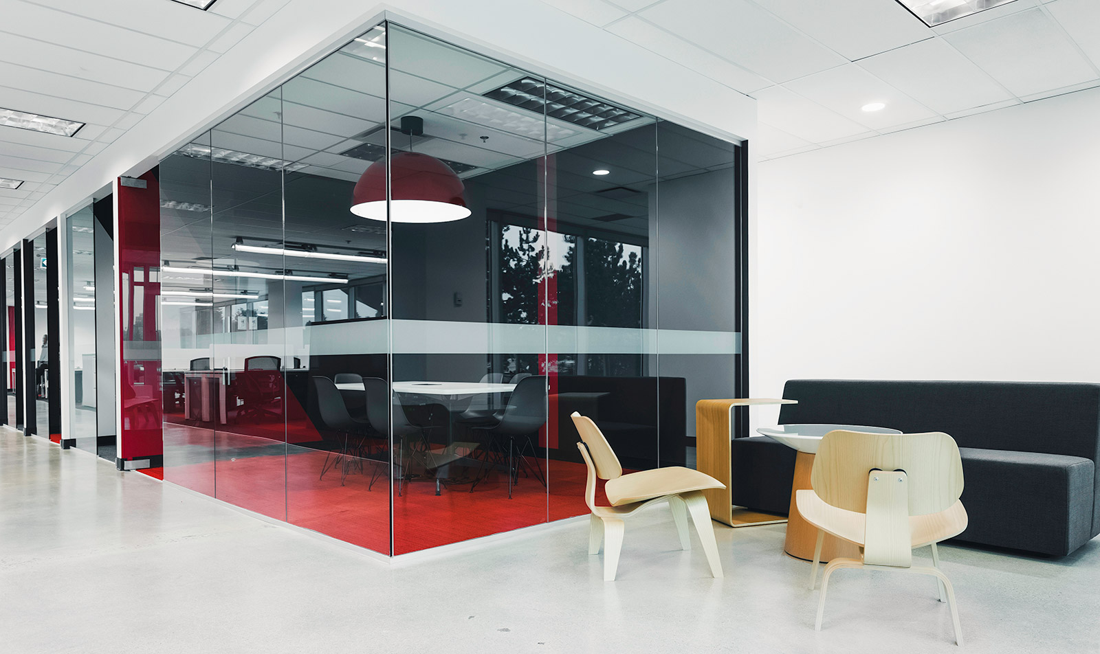 Flight Centre office interior design showing glass wall meeting rooms and bright white lighting