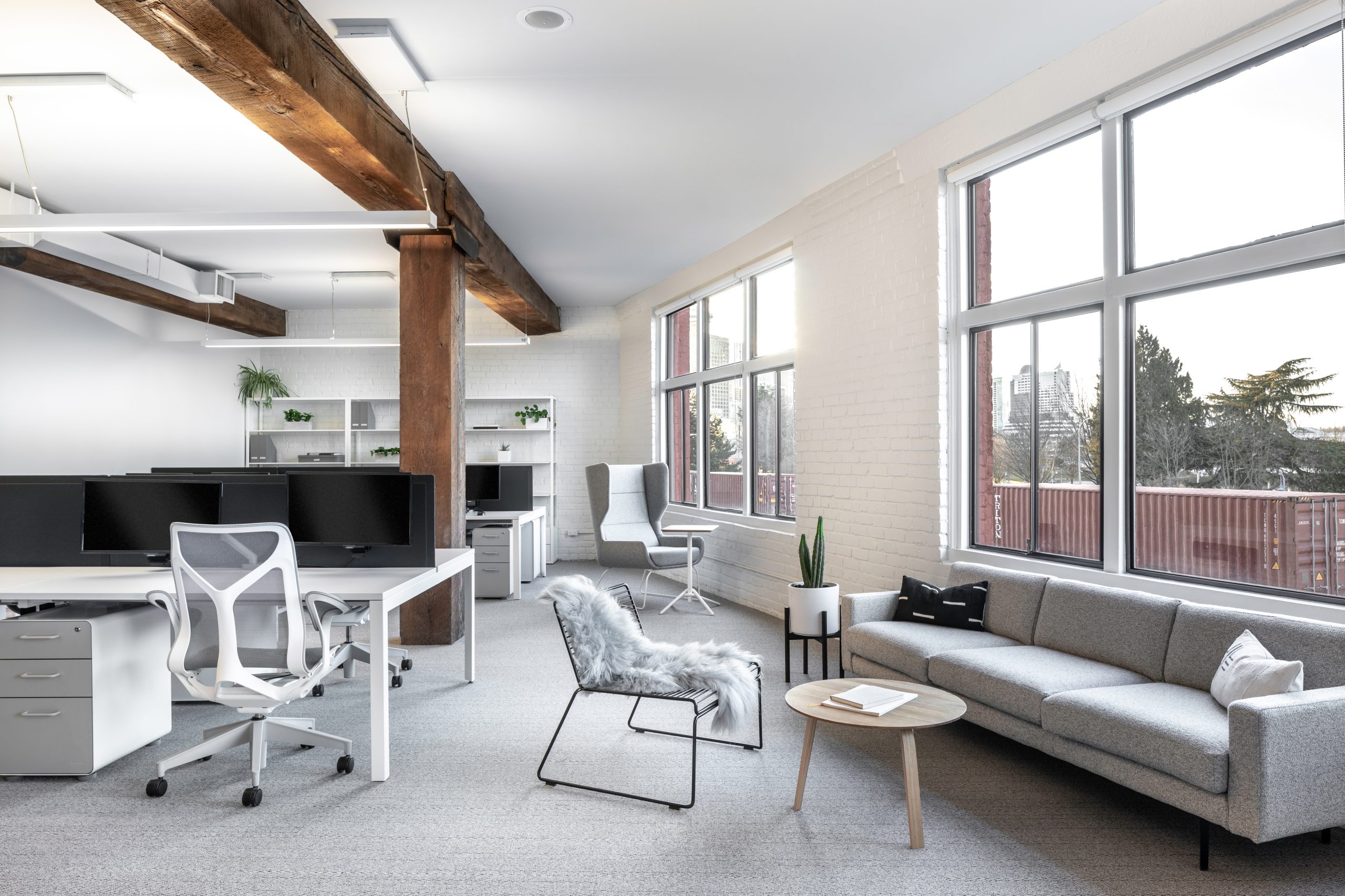 Bright and white workspace interior, showing lounge area and big windows at Cutler's studio space in Vancouver BC