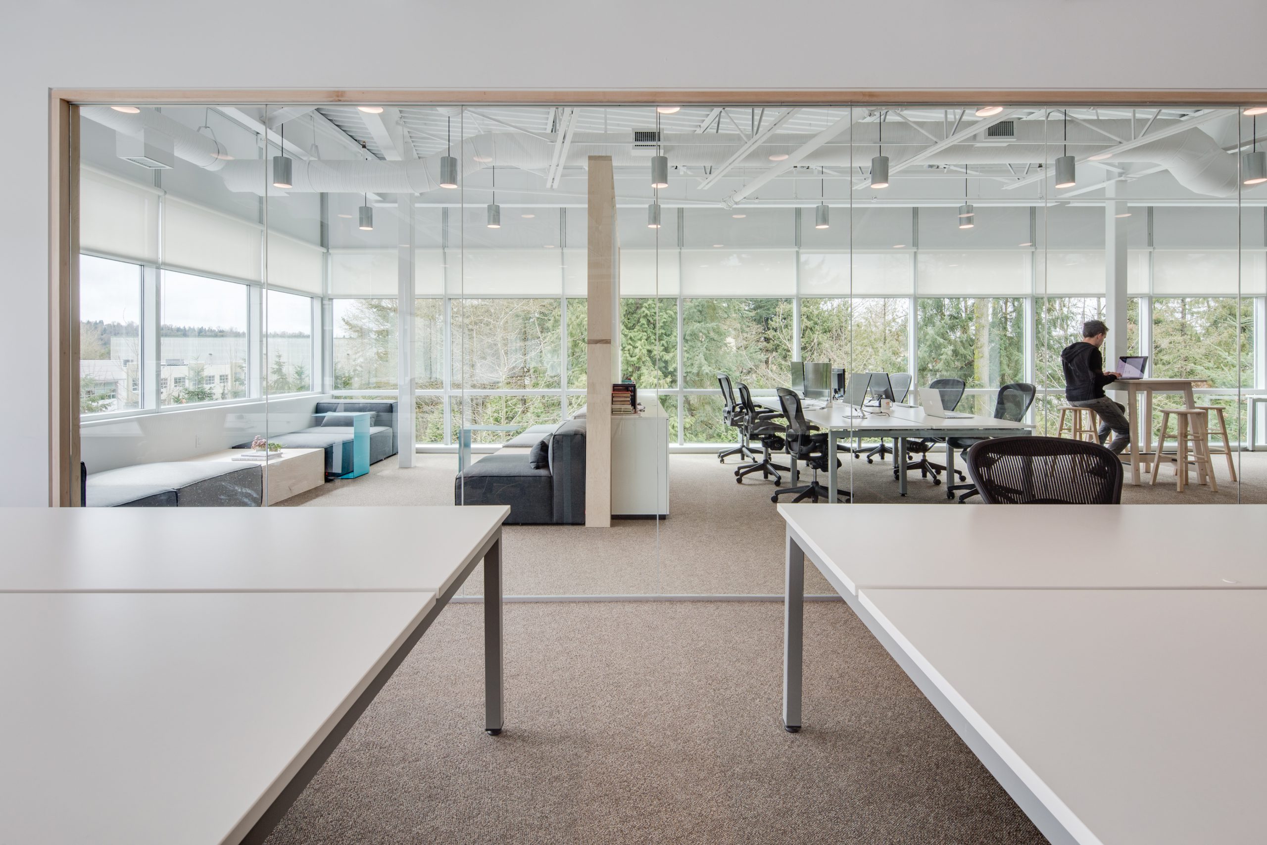 Office interior with big windows and lots of light, showing lounge and conference room at Jane Software in Vancouver BC