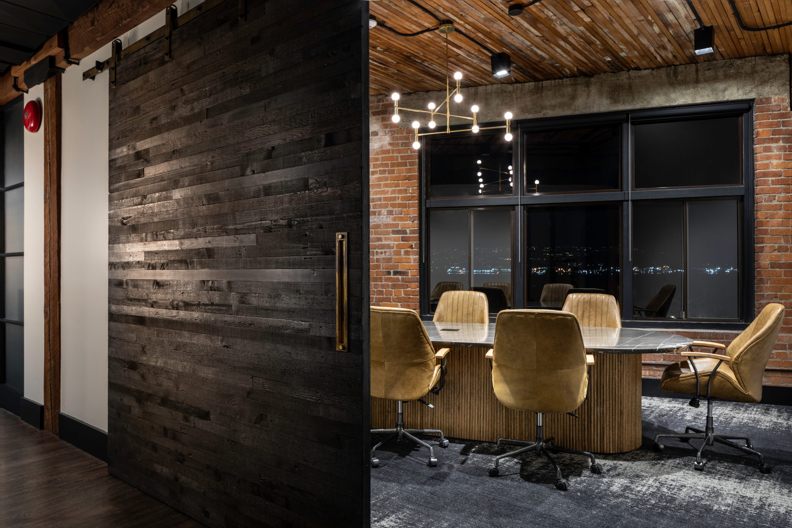 Elegant office interior showing walls made of brick, wood, and conference room at Key Marketing in Vancouver BC