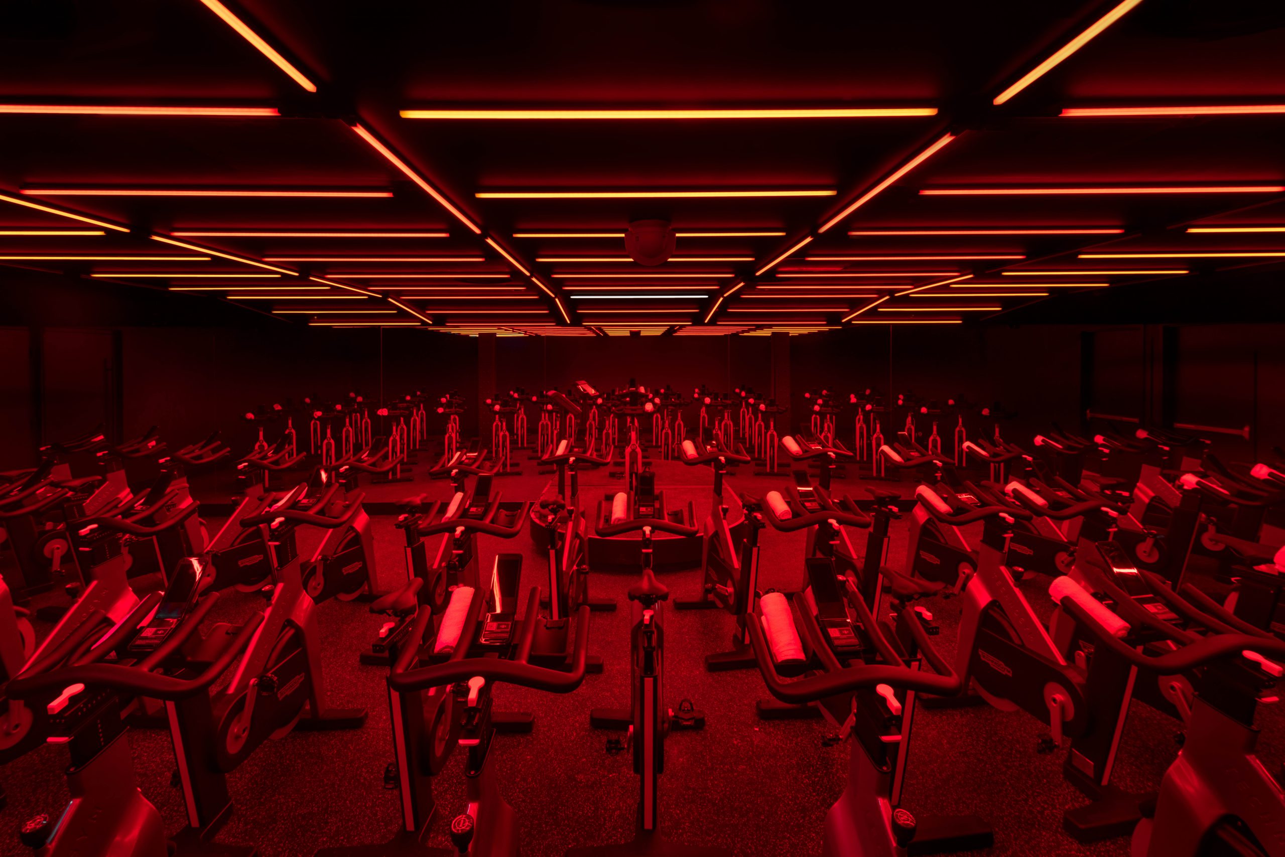Sweat and Tonic in Toronto ON Gym Design Sping room with red lighting by Cutler