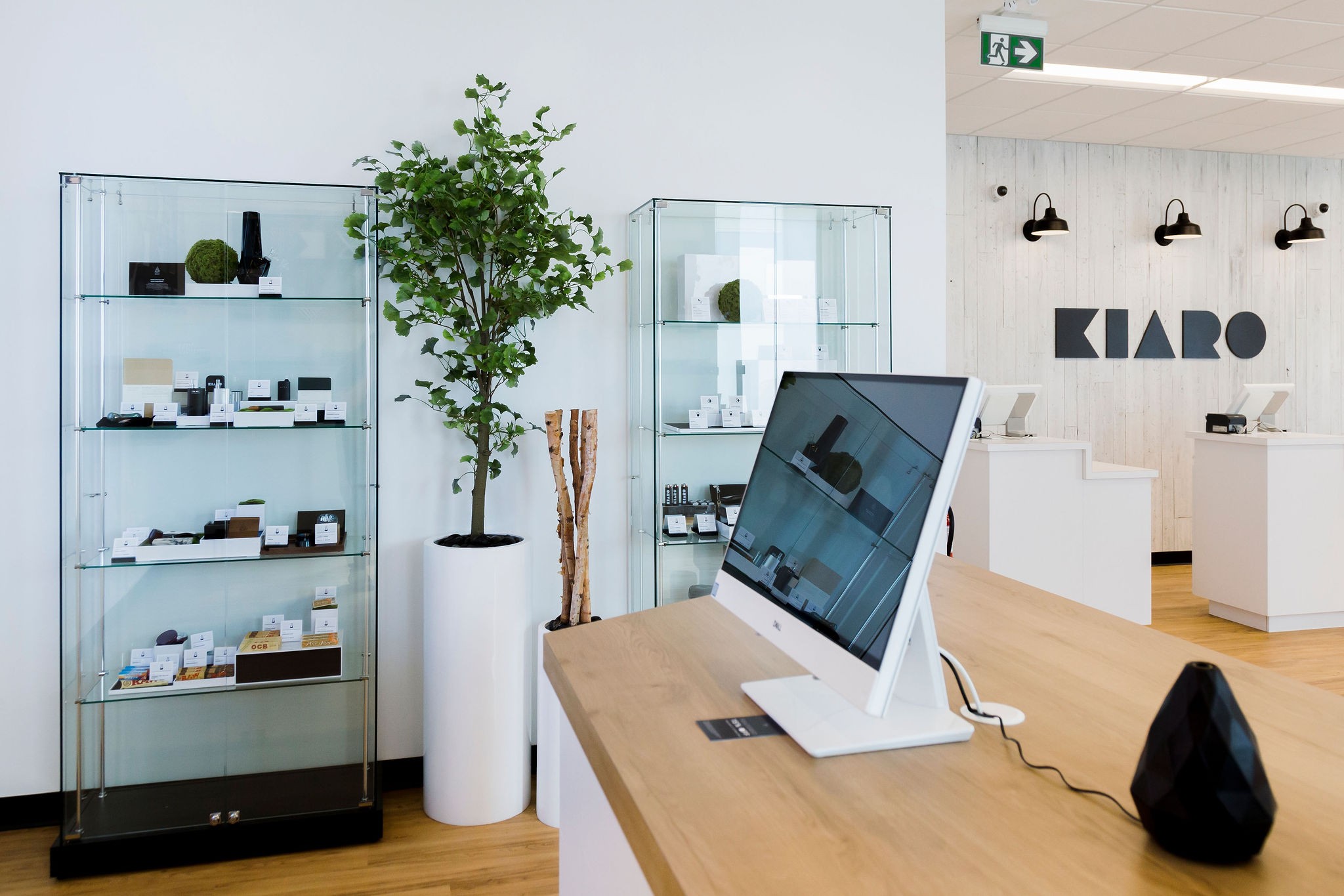 Kiaro cannabis store showing customer product kiosks, display units, branded wall, desks, and bright interior