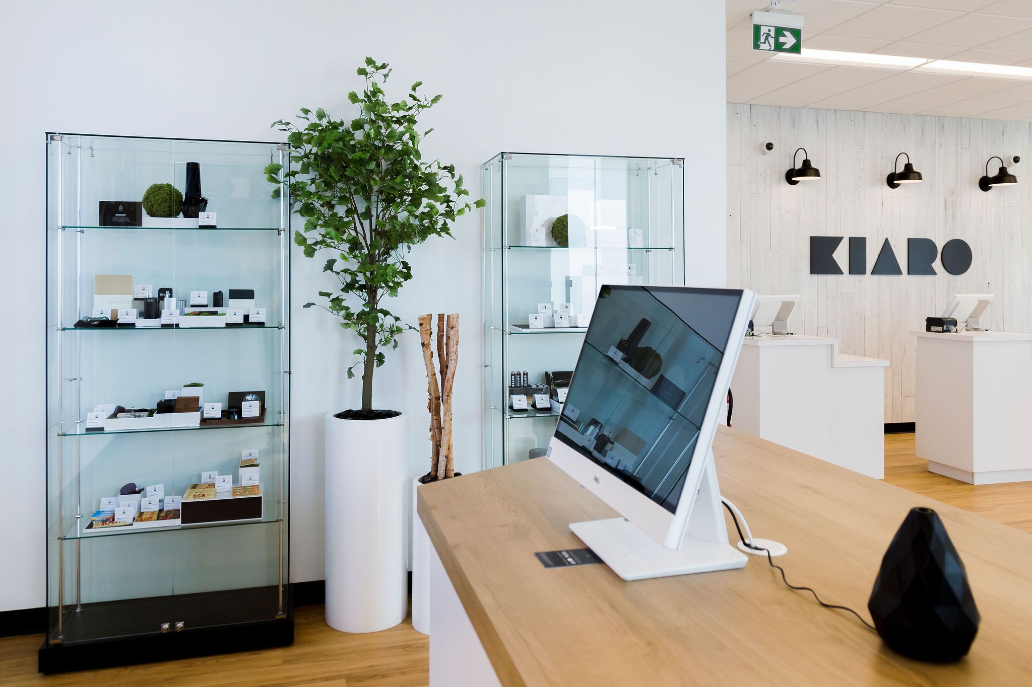 Kiaro cannabis store showing customer product kiosks, display units, branded wall, desks, and bright interior