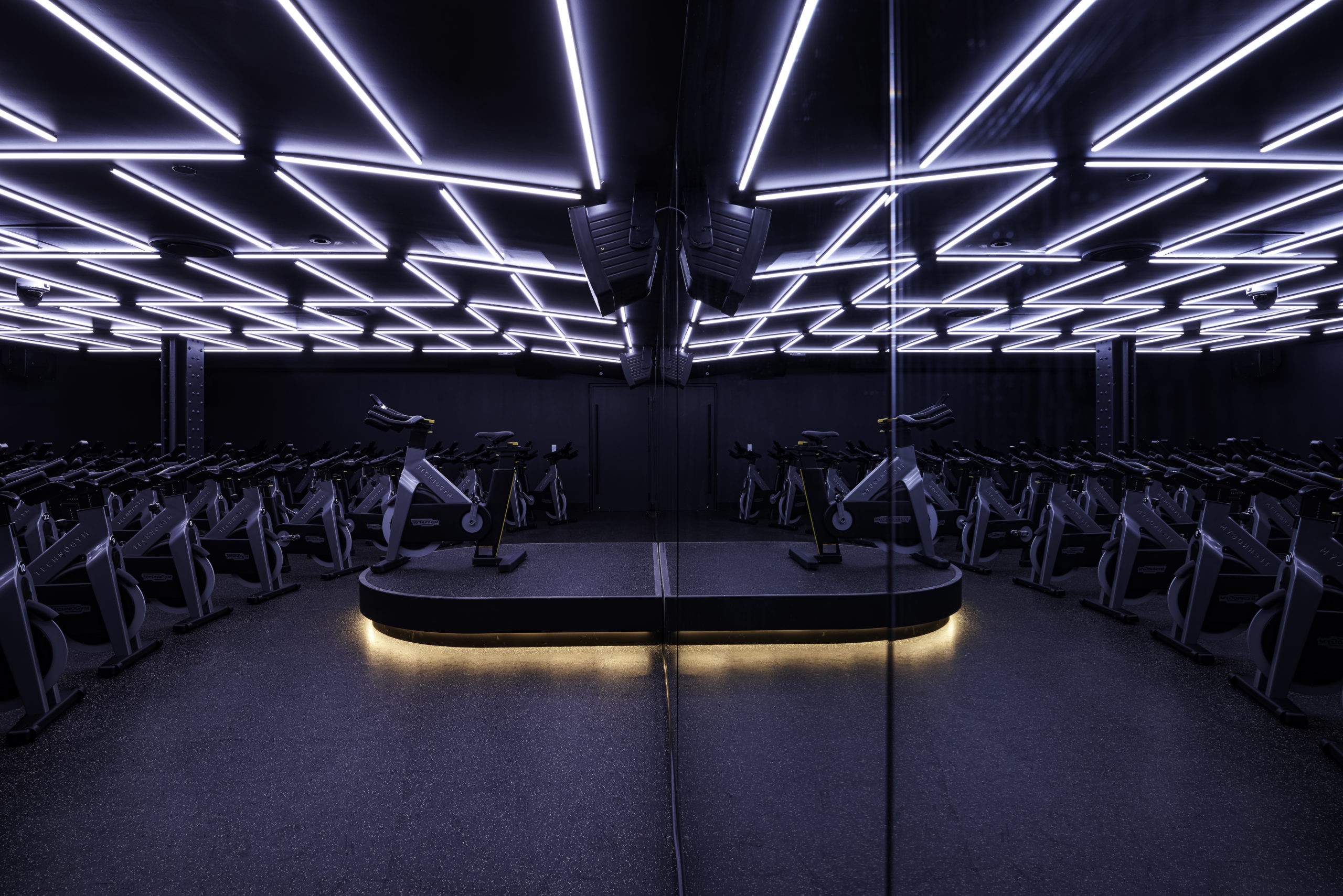 Sweat and Tonic in Toronto ON Gym Design Spin room and lighting by Cutler