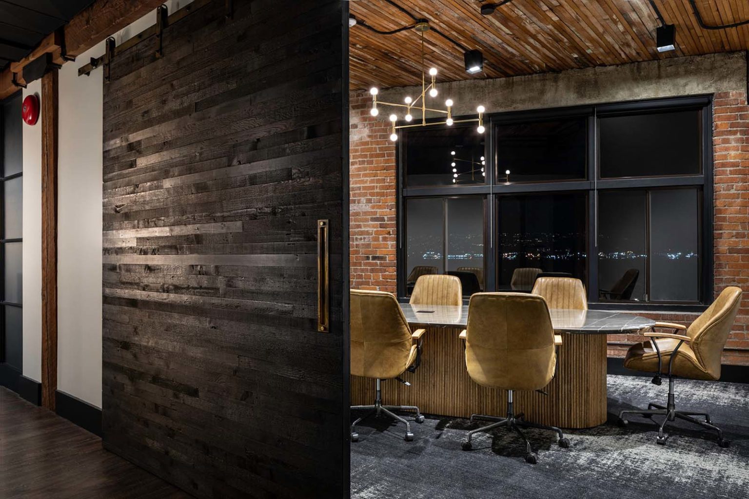 Reclaimed wood feature wall and natural materials in a Cutler-designed office