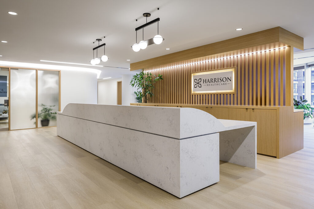 Medical reception desk with a lowered accessible counter section and barrier-free approach at Harrison Healthcare in Vancouver