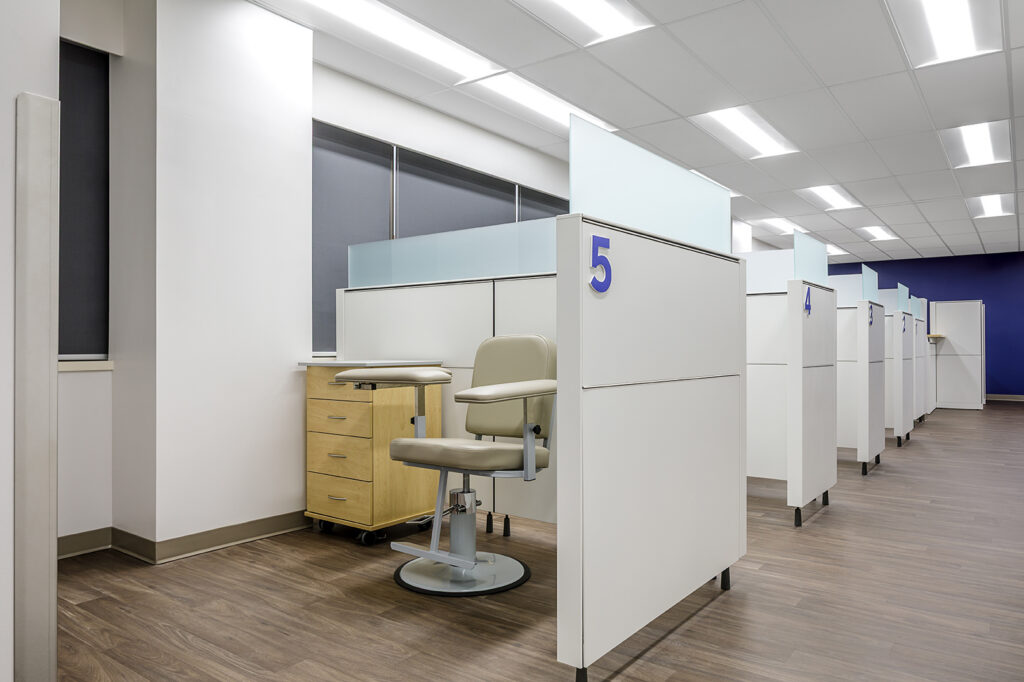 Numbered patient collection bays providing clear wayfinding cues in a LifeLabs medical facility designed by Cutler