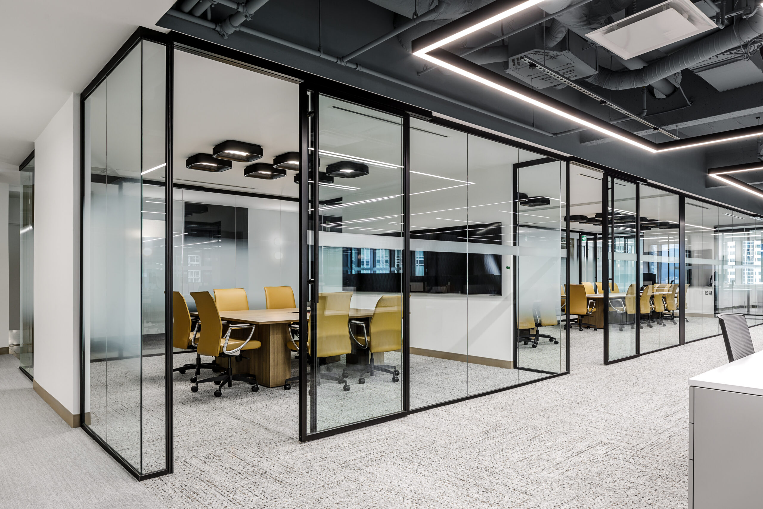 Glass partitions bringing daylight deep into an office floor plate in a Cutler-designed workspace