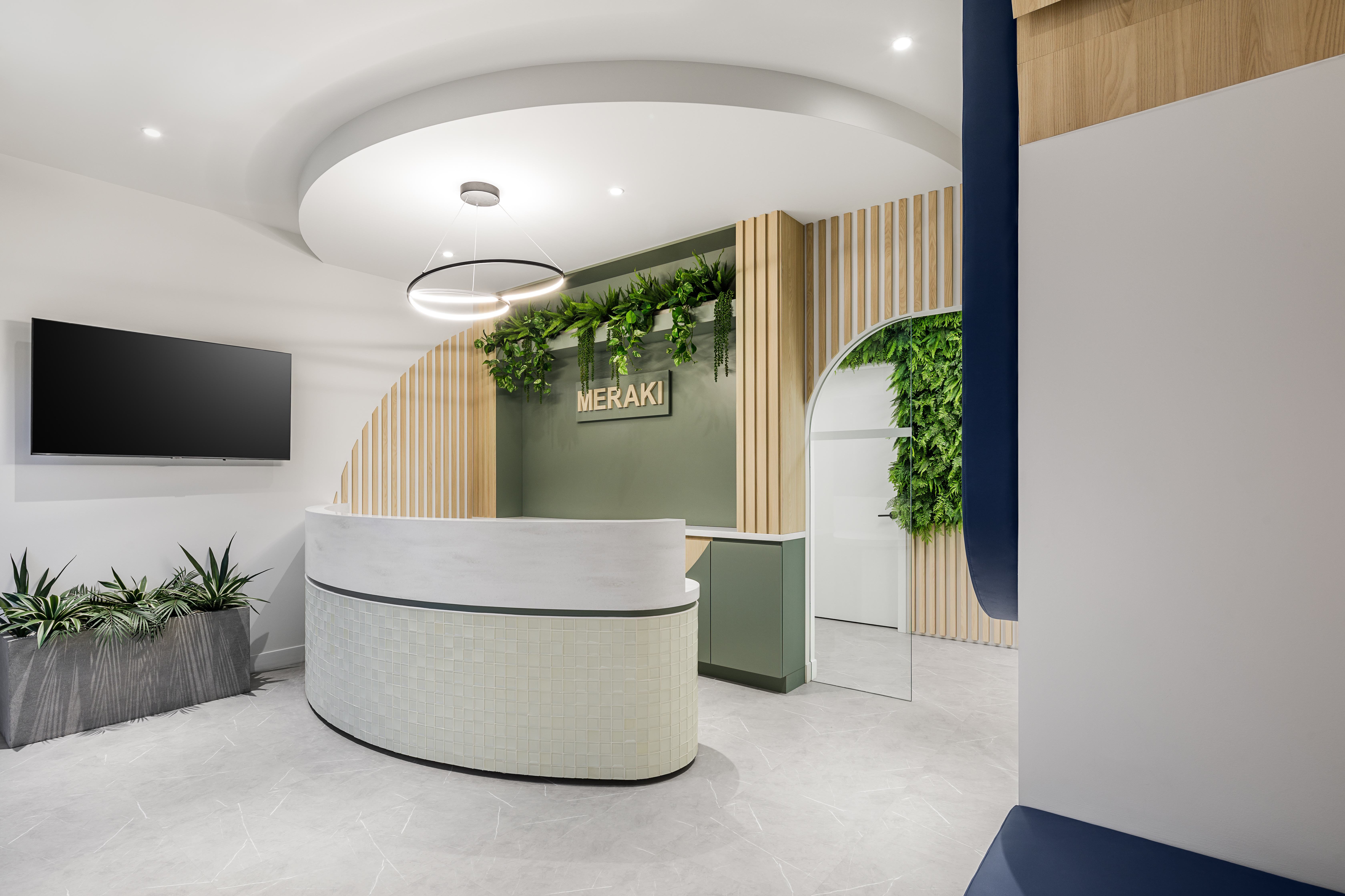 Modern dental office reception area featuring natural materials, indoor plants, and warm ambient lighting