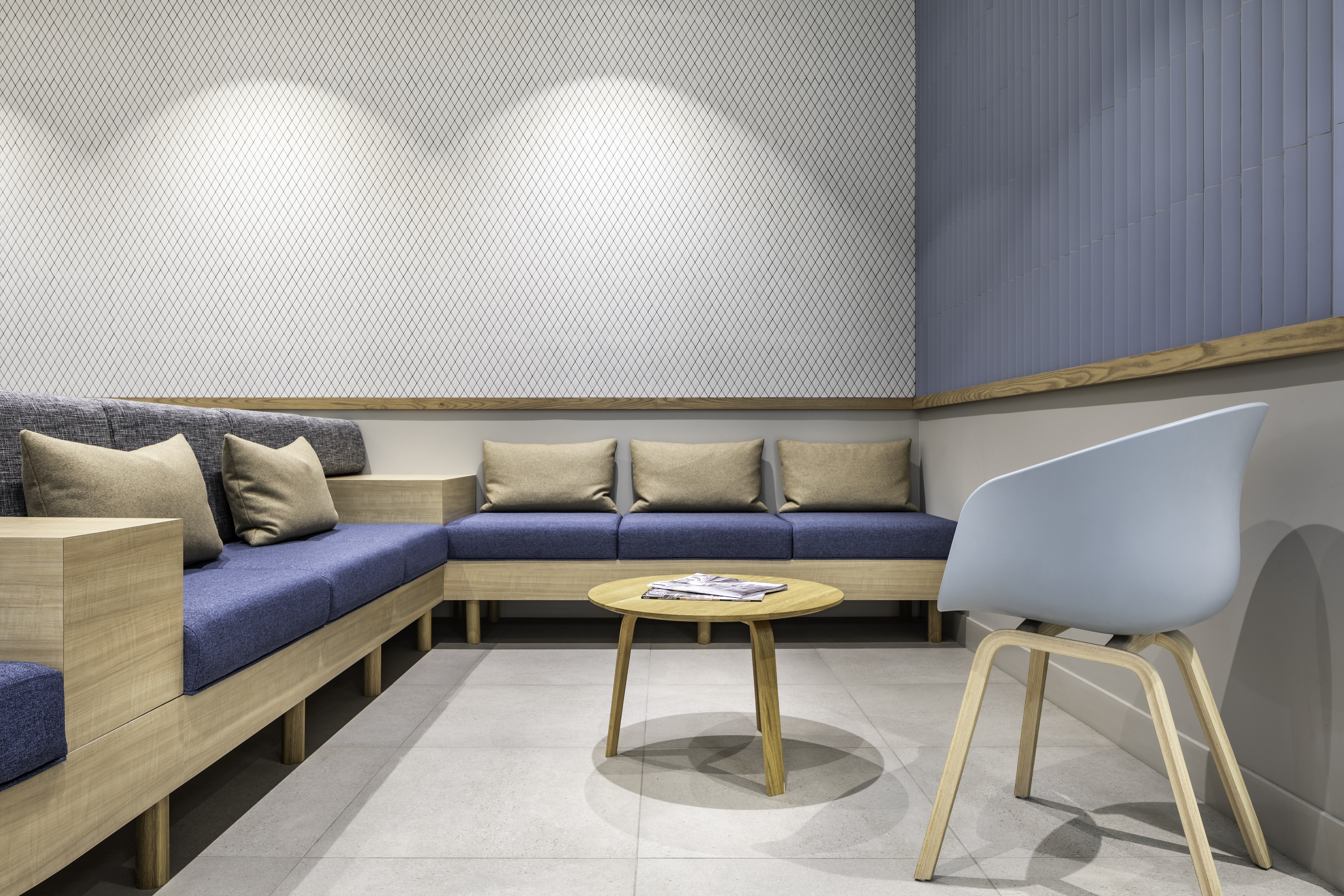 Modern dental office reception area featuring natural materials, indoor plants, and warm ambient lighting